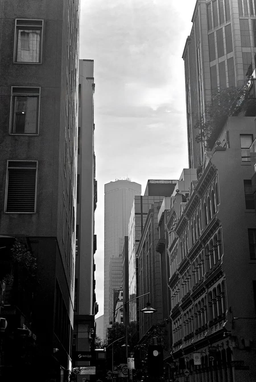 City laneway between tall buildings, black and white